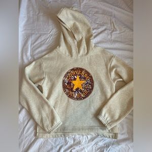 Beige Converse hoodie with red, pink, and bronze statement star